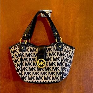 Michael Kors Black and Cream MK Patterned Handbag.Gently used.16”x9”